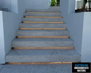 Concrete stairs with wooden steps leading up to a well-lit area
