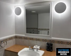 Modern bathroom with a mirror above the sink, showcasing the clean and minimalistic design